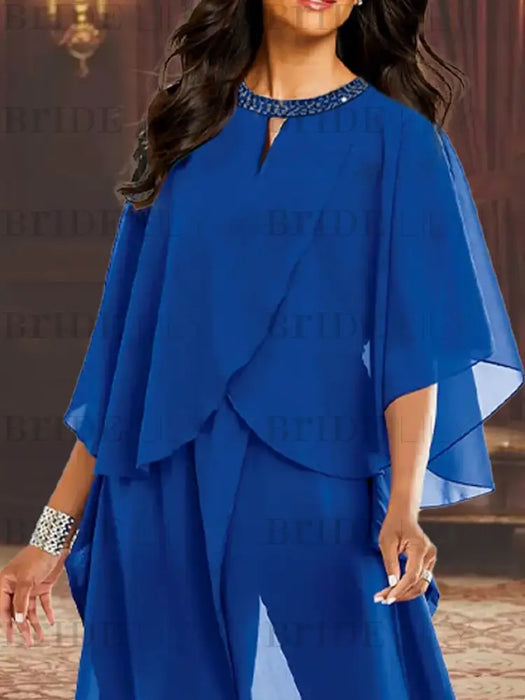 Close-up of the beaded keyhole neckline on the royal blue chiffon top