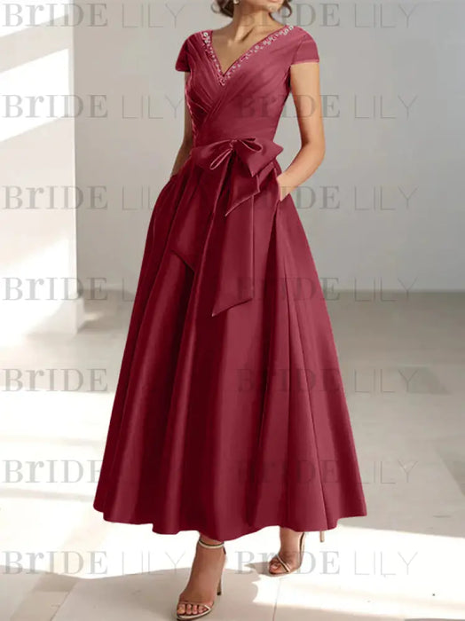 Burgundy satin mother of the bride tea length dress with bow and pockets