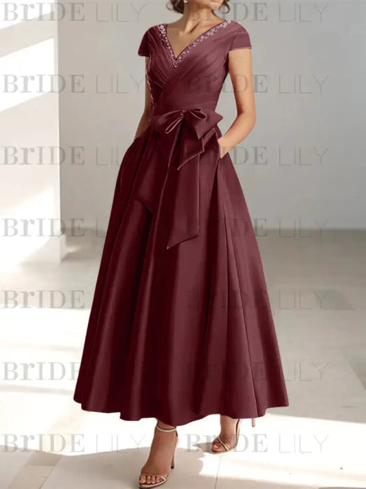 Cabernet satin mother of the bride tea length dress with bow and pockets