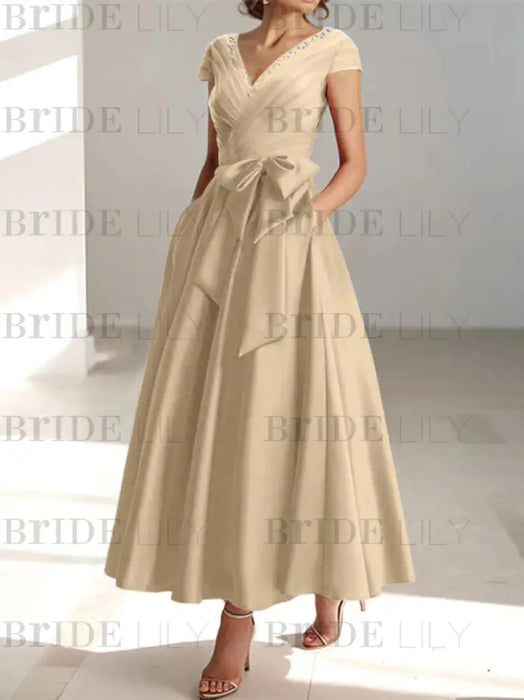 Champagne satin mother of the bride tea length dress with bow and pockets