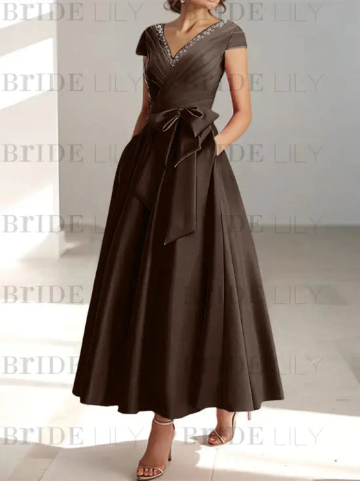 Chocolate satin mother of the bride tea length dress with bow and pockets