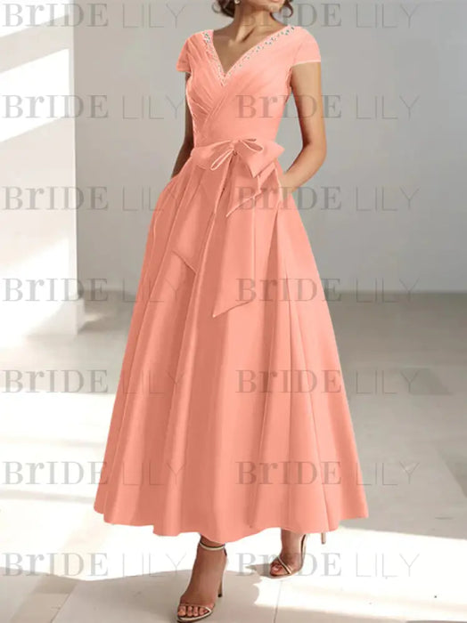 Coral satin mother of the bride tea length dress with bow and pockets