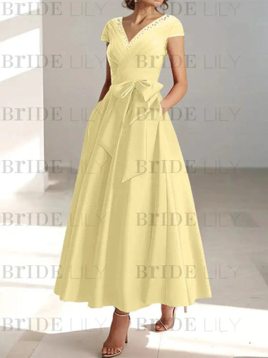 Daffodil satin mother of the bride tea length dress with bow and pockets