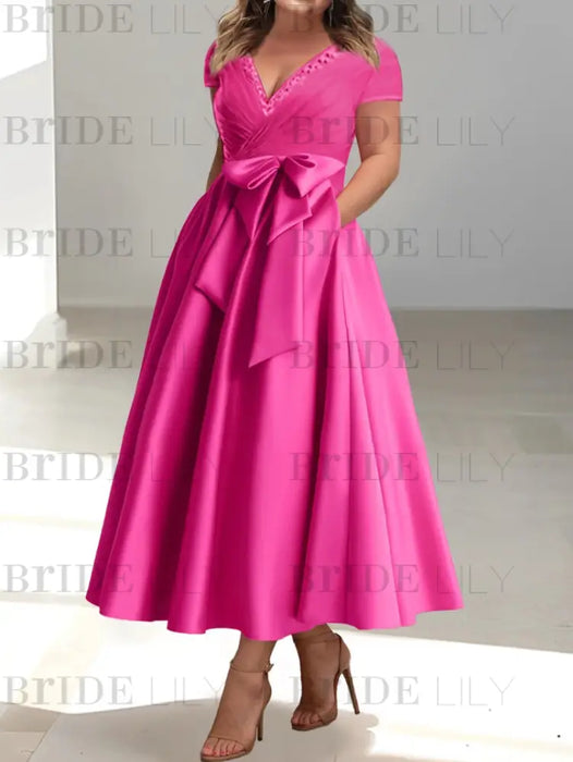 Fuchsia satin tea length dress worn by a curve model