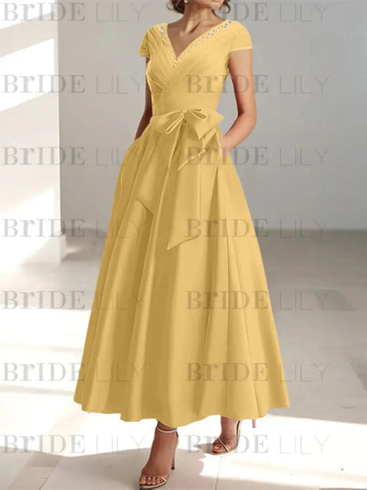 Gold satin mother of the bride tea length dress with bow and pockets
