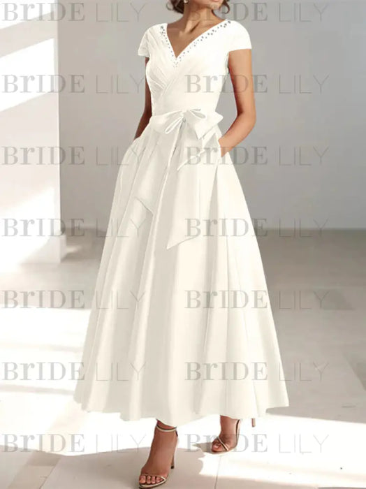 Ivory satin mother of the bride tea length dress with bow and pockets