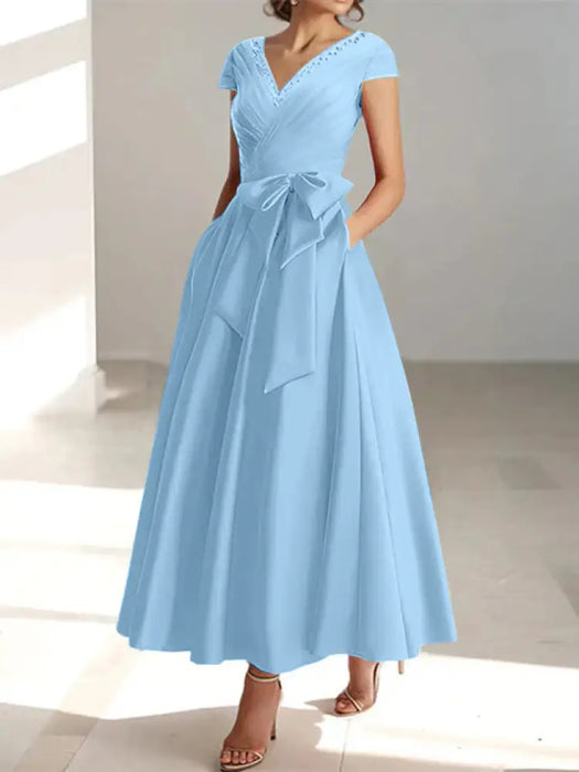 Light blue satin tea length dress with a tie bow and pockets