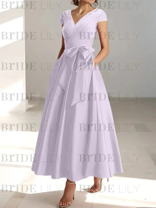 Lilac satin tea length dress with a tie bow