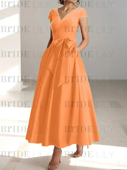 Orange satin mother of the bride tea length dress with bow and pockets