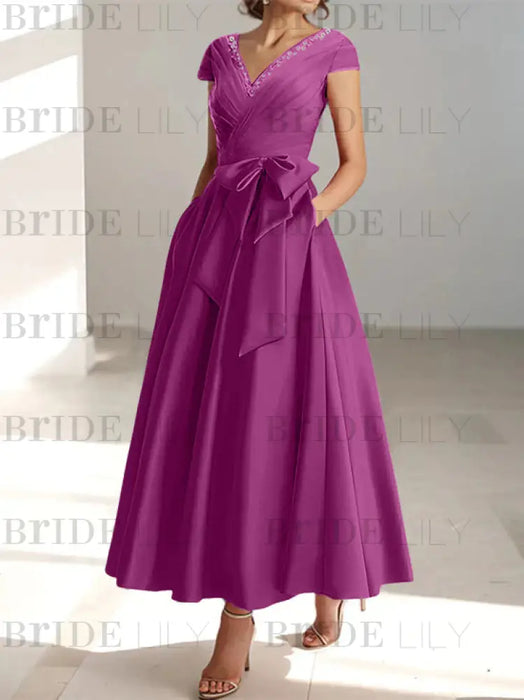 Orchid satin mother of the bride tea length dress with bow and pockets