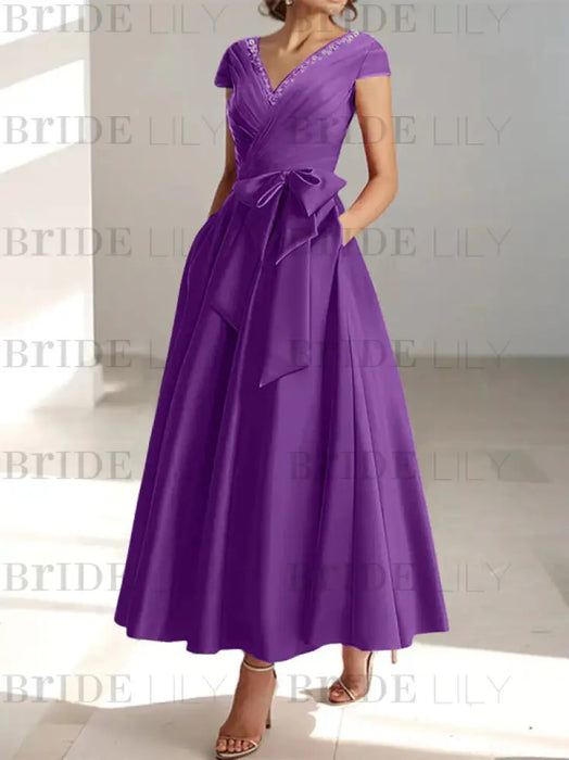 Plum satin mother of the bride tea length dress with bow and pockets