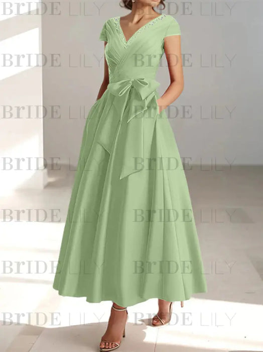 Sage satin mother of the bride tea length dress with bow and pockets