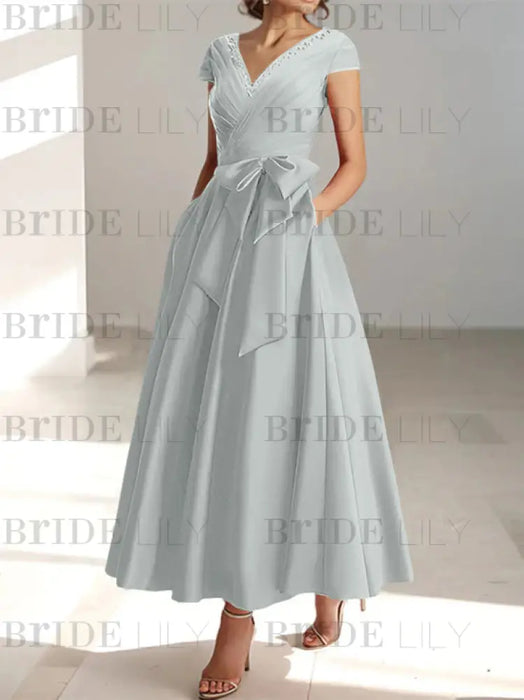 Silver satin mother of the bride tea length dress with bow and pockets
