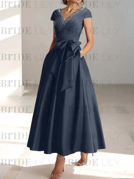 Slate blue satin tea length dress with a tie bow