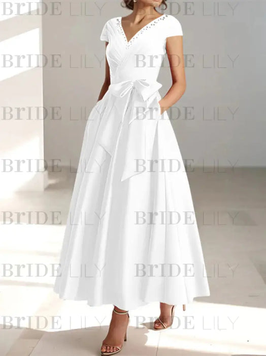 White satin mother of the bride tea length dress with bow and pockets