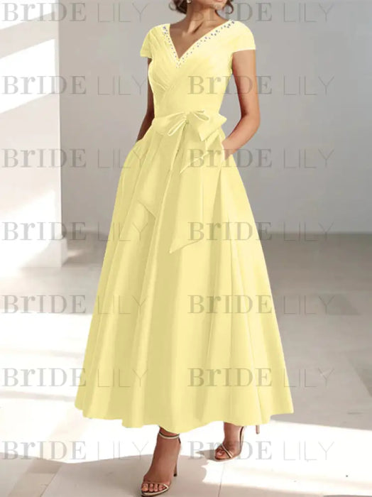 Yellow satin mother of the bride tea length dress with bow and pockets