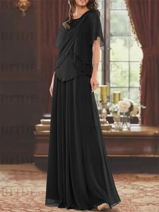 Black beaded chiffon overtop with a matching floor-length skirt