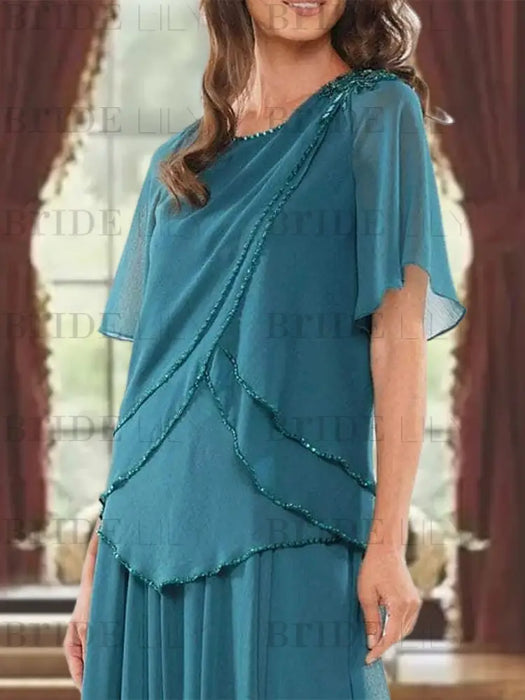 Close-up of the beaded scalloped tiers on the teal chiffon top