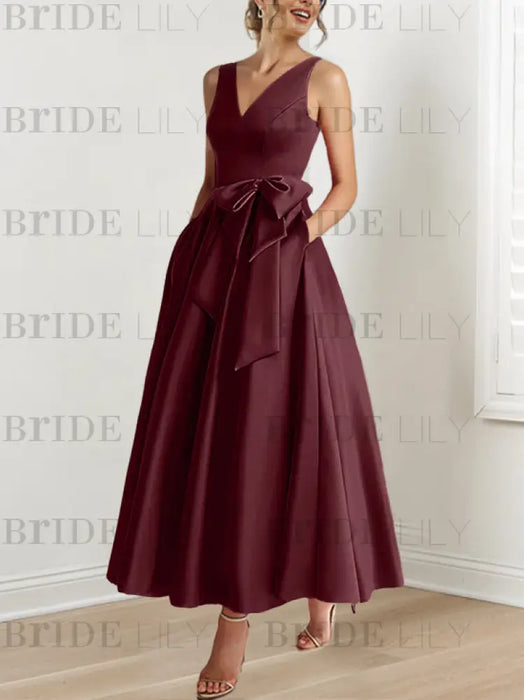 Burgundy satin ankle length dress with a bow sash