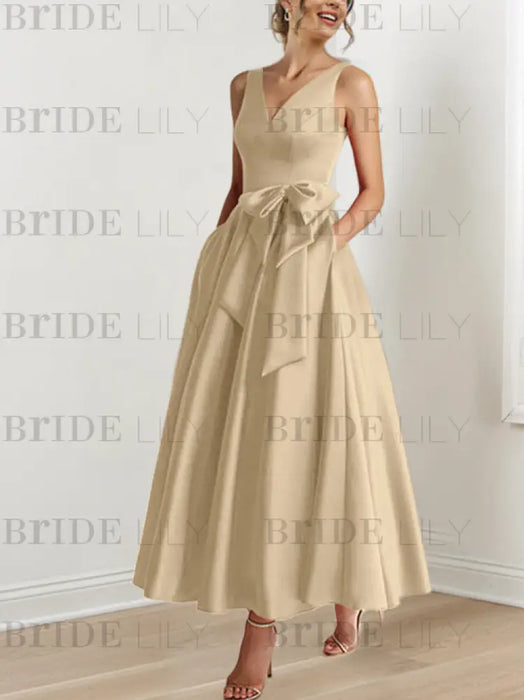 Champagne satin ankle length dress with a bow sash