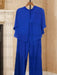 Royal blue chiffon cape top and wide leg trousers on a hanger