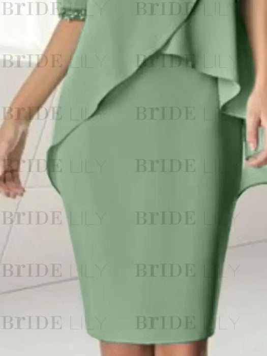 Close-up of the chiffon overlay hem over the sage green skirt