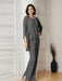 Grey chiffon three piece pantsuit worn indoors with the jacket open