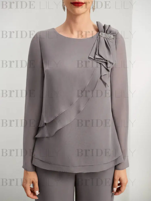 Close-up of crystal bar trim and ruffle on grey chiffon top