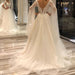 Elegant Short-Sleeve Backless A-Line Wedding Gown with Deep V-Neck, Lace Appliques, and Pearls
