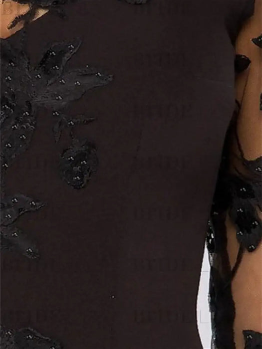 Close view of the beaded black floral lace