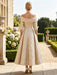 Back view of gold floral jacquard dress with bow shoulder