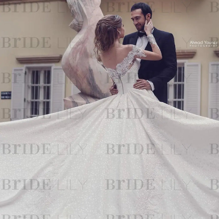 Elegant Off-the-Shoulder A-Line Wedding Gown with Lace Backless Detail and Long Sleeves