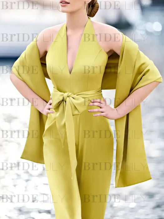 Close-up of the halter neckline and bow belt in chartreuse with a shawl