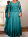 Lace and tulle gown with sheer sleeves in teal