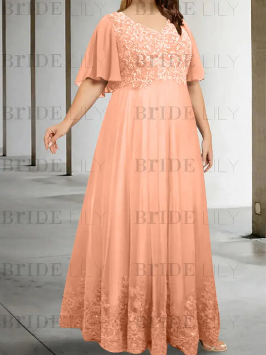 Plus size peach chiffon gown with a lace bodice and lace hem band