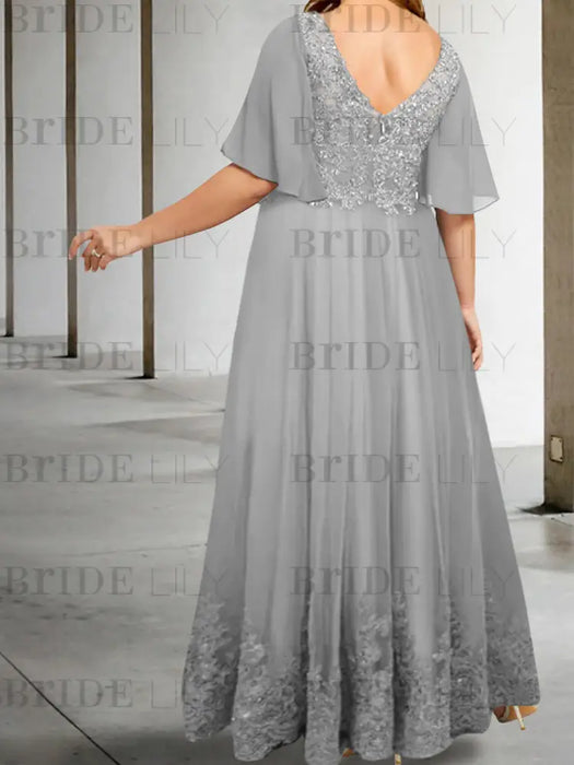 Back view of the silver chiffon gown with a lace hem band