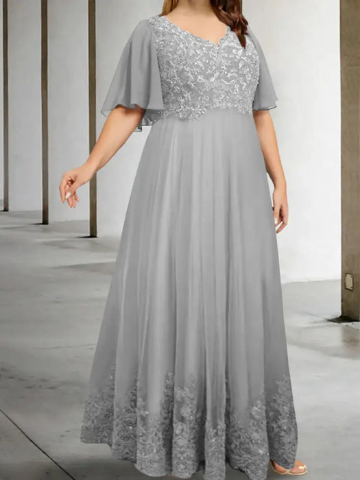 Plus size silver chiffon gown with a sequin lace bodice and lace hem