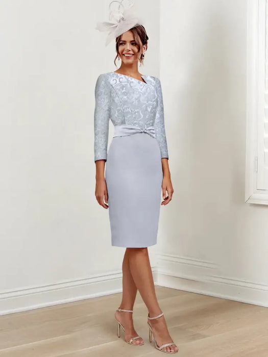 Silver blue knee length sheath dress with a metallic lace bodice and bow belt
