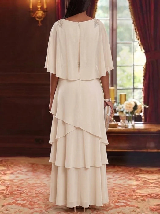 Back view of ivory chiffon cape sleeve gown with tiered skirt