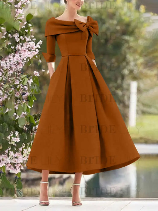 Burnt Orange mother of the bride dress with folded collar and bow detail