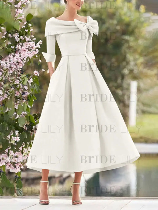 Off White mother of the bride dress with folded collar and bow detail