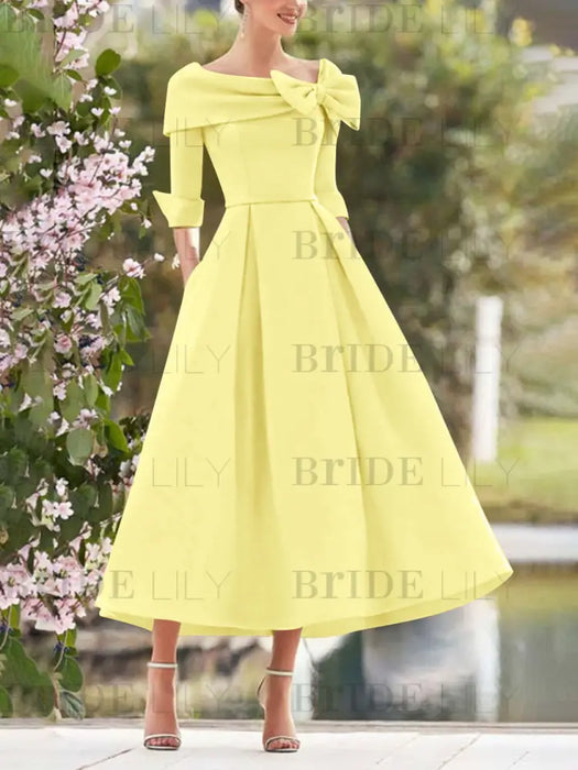 Yellow mother of the bride dress with folded collar and bow detail