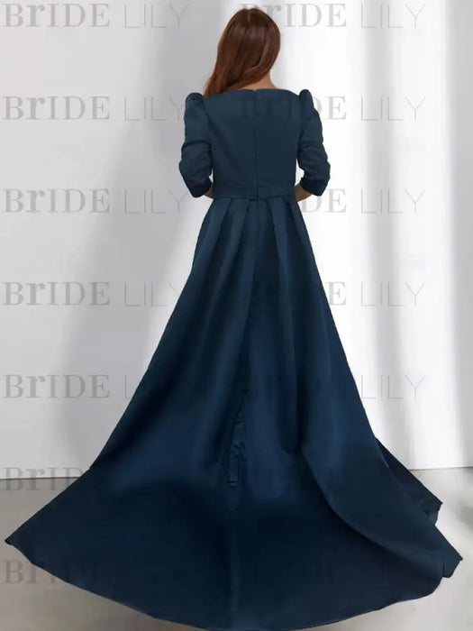 Back view of navy satin dress with box pleated skirt