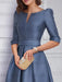 Close-up of the notch neckline and self belt in dusty blue satin