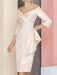 Off the shoulder sheath dress with a cascading side drape in blush pink