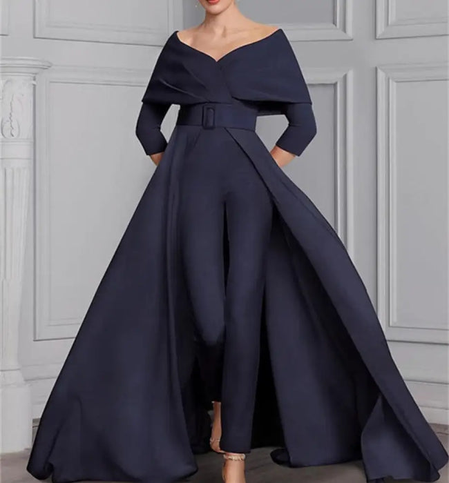 Navy off the shoulder jumpsuit with a belted waist and overskirt