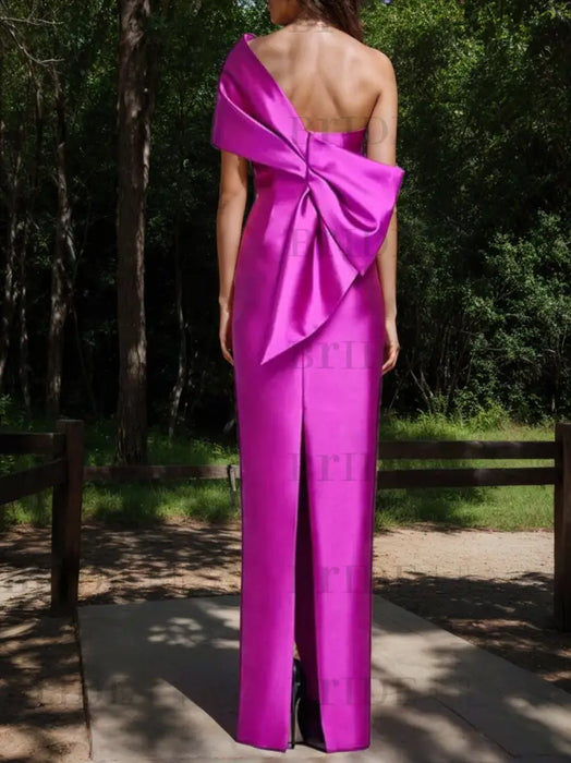 Back view of the fuchsia column gown with a bow back