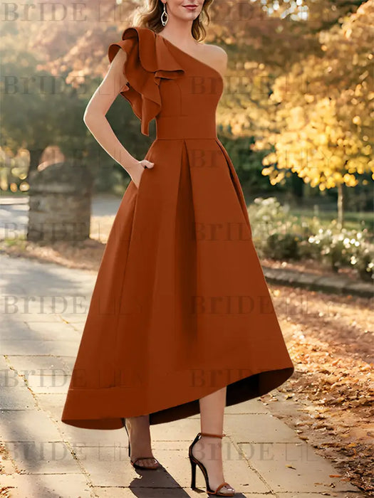 One shoulder mikado dress with a double ruffle in rust orange