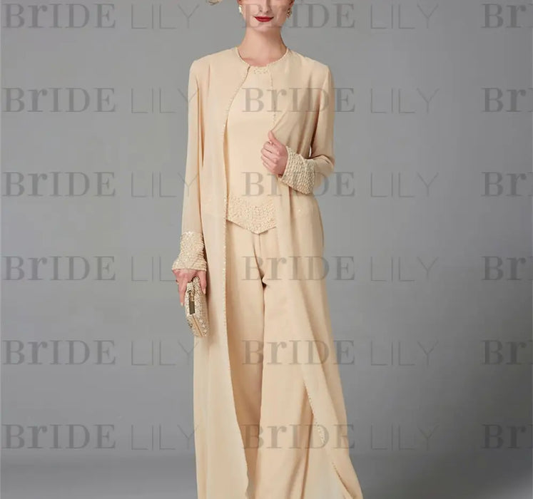 Model in the champagne chiffon pantsuit with the duster coat worn open