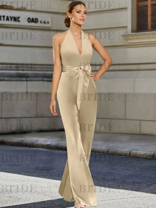 Satin halter jumpsuit with a bow belt in champagne